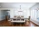 Dining room with wooden floors, a rustic chandelier, and stylish artwork above the table at 48 Blue Heron Ln, Roxboro, NC 27574