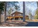 Spacious lake house with a wraparound porch, showcasing the natural beauty of the surroundings at 48 Blue Heron Ln, Roxboro, NC 27574