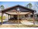 Lake house exterior with a porte-cochere, star decoration, and stone accents at 48 Blue Heron Ln, Roxboro, NC 27574