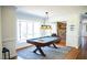 Well-lit game room with a pool table, bay window, and stone fireplace in the background at 48 Blue Heron Ln, Roxboro, NC 27574