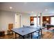Spacious game room with ping pong table and an open doorway to the living area at 48 Blue Heron Ln, Roxboro, NC 27574