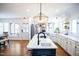 Modern kitchen with an island and stainless steel appliances. Hardwood floors throughout at 48 Blue Heron Ln, Roxboro, NC 27574