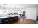 Bright kitchen with white cabinets, island with seating, and hardwood floors at 48 Blue Heron Ln, Roxboro, NC 27574