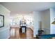 View of kitchen showcasing center island, pendant lights, and stainless-steel appliances from game room at 48 Blue Heron Ln, Roxboro, NC 27574