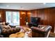 Cozy living room with wood paneling, and sliding glass doors to the back patio at 48 Blue Heron Ln, Roxboro, NC 27574