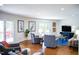 Open living room with hardwood floors, comfortable seating, and access to outdoor deck at 48 Blue Heron Ln, Roxboro, NC 27574