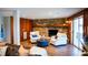Cozy living room with a stone fireplace, chairs, and wood laminate flooring at 48 Blue Heron Ln, Roxboro, NC 27574