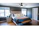 Cozy main bedroom featuring hardwood floors, a ceiling fan, and natural light at 48 Blue Heron Ln, Roxboro, NC 27574
