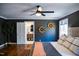 Comfortable main bedroom featuring hardwood floors and a peek into the ensuite bathroom at 48 Blue Heron Ln, Roxboro, NC 27574