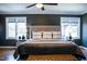 Spacious main bedroom with large windows, ceiling fan and dark accent wall paint at 48 Blue Heron Ln, Roxboro, NC 27574