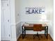 Cozy office nook featuring a modern desk, leather chair, and charming lake-themed decor at 48 Blue Heron Ln, Roxboro, NC 27574