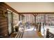 Inviting covered porch featuring chairs and a view of the surrounding wooded landscape at 48 Blue Heron Ln, Roxboro, NC 27574