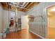 Unfinished basement featuring wood-look floor, painted walls, utility equipment, and storage shelving at 5036 Isabella Cannon Dr, Raleigh, NC 27612