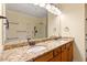Bathroom featuring a double vanity with granite countertops, a large mirror, and modern lighting at 5036 Isabella Cannon Dr, Raleigh, NC 27612