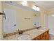 Bright bathroom featuring double sinks with granite countertops and a large mirror at 5036 Isabella Cannon Dr, Raleigh, NC 27612