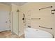 Modern bathroom featuring a soaking tub, frameless glass shower, and sleek fixtures at 5036 Isabella Cannon Dr, Raleigh, NC 27612