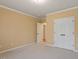 Bedroom with neutral carpet, closet, and doorways leading to other rooms at 5036 Isabella Cannon Dr, Raleigh, NC 27612