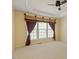 Bedroom with ceiling fan, carpet, and large window with stylish curtains at 5036 Isabella Cannon Dr, Raleigh, NC 27612
