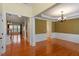 Elegant dining room boasting hardwood floors, crown molding, and stylish chandelier at 5036 Isabella Cannon Dr, Raleigh, NC 27612