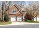 Charming red brick two-story home with a two-car garage and mature landscaping at 5036 Isabella Cannon Dr, Raleigh, NC 27612