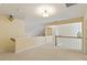 Second-story hallway is bright and airy, features carpeted floors and ornamental lighting fixtures at 5036 Isabella Cannon Dr, Raleigh, NC 27612