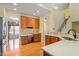 Spacious kitchen with a built-in desk, stainless steel appliances, and wood flooring at 5036 Isabella Cannon Dr, Raleigh, NC 27612