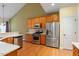 Modern kitchen featuring stainless steel appliances, granite counters, and ample cabinet space at 5036 Isabella Cannon Dr, Raleigh, NC 27612