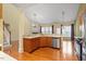 Bright kitchen featuring wood floors, stainless steel appliances, and granite countertops at 5036 Isabella Cannon Dr, Raleigh, NC 27612
