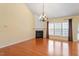 Bright living room with fireplace, large windows, and hardwood flooring at 5036 Isabella Cannon Dr, Raleigh, NC 27612