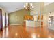 Open floor plan living room with a fireplace, stainless kitchen and wood floors at 5036 Isabella Cannon Dr, Raleigh, NC 27612