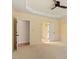 Spacious main bedroom with light yellow walls and doorway access to a walk-in closet at 5036 Isabella Cannon Dr, Raleigh, NC 27612