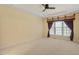 Spacious main bedroom features a ceiling fan, large windows, and neutral carpeting at 5036 Isabella Cannon Dr, Raleigh, NC 27612