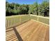 A freshly built wooden back deck, with room for entertaining, overlooks a lush green area at 60 Moonraker Dr, Spring Hope, NC 27882