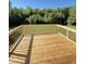 A freshly built wooden back deck, with room for entertaining, overlooks a lush green area at 60 Moonraker Dr, Spring Hope, NC 27882