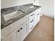 Bathroom double vanity with stone countertop, white cabinets, and black hardware at 60 Moonraker Dr, Spring Hope, NC 27882