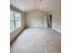 A spacious bedroom with a high ceiling, a large window, and unfinished floors at 60 Moonraker Dr, Spring Hope, NC 27882