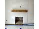 Close-up of a modern fireplace with white shiplap and a wooden mantle at 60 Moonraker Dr, Spring Hope, NC 27882
