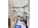 A kitchen with white subway tiles, white upper cabinets, wood lower cabinets, and granite countertops at 60 Moonraker Dr, Spring Hope, NC 27882