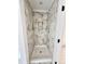 Shower with marble tile, built-in shelving, and tile flooring at 60 Moonraker Dr, Spring Hope, NC 27882