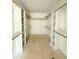 Walk-in closet with white shelving and wooden rails at 60 Moonraker Dr, Spring Hope, NC 27882