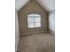 Finished attic with carpet, neutral paint, a window, and natural light at 6002 River Estates Dr, Knightdale, NC 27545
