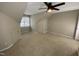Finished attic offers carpet, neutral paint, a ceiling fan, and a window with natural light at 6002 River Estates Dr, Knightdale, NC 27545