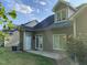 A fenced backyard with green grass, landscaping, and a door leading to a patio at 6002 River Estates Dr, Knightdale, NC 27545