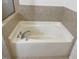 Bathroom features a white soaking tub with modern fixtures and tile surround at 6002 River Estates Dr, Knightdale, NC 27545
