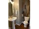 Well-appointed half bathroom with stylish pedestal sink and decorative wall paneling at 6002 River Estates Dr, Knightdale, NC 27545