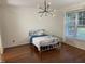 Bright bedroom featuring wood floors, a large window, and modern lighting fixtures at 6002 River Estates Dr, Knightdale, NC 27545