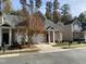 Charming home with brick accents, a two-car garage, mature trees, and sidewalk at 6002 River Estates Dr, Knightdale, NC 27545