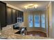 Bright kitchen featuring granite countertops, stainless appliances, and a breakfast nook with large windows at 6002 River Estates Dr, Knightdale, NC 27545