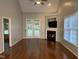 Bright living room features a fireplace with built-ins and hardwood flooring throughout at 6002 River Estates Dr, Knightdale, NC 27545