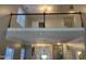A bright, two-story living room space with a chandelier and a staircase overlooking the living area at 6002 River Estates Dr, Knightdale, NC 27545